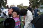 Parents assisting their children to view the evening sky