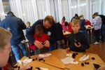 Members of the Voortrekker Club assisting children with their binoculars 